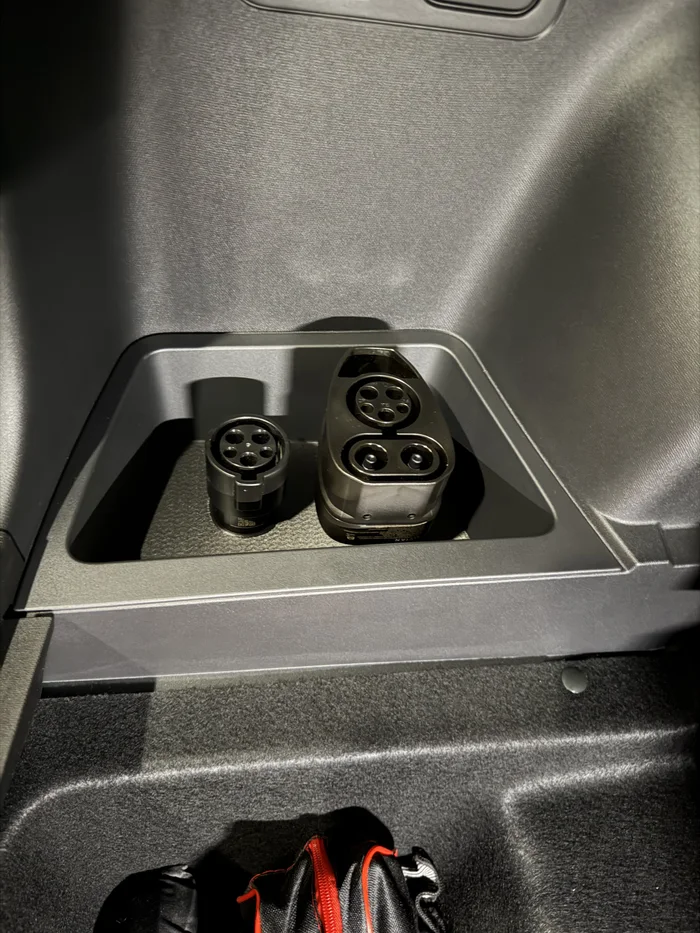 Rivian R2 rear driver cubby NACS adapter holder, a preview image from Printables